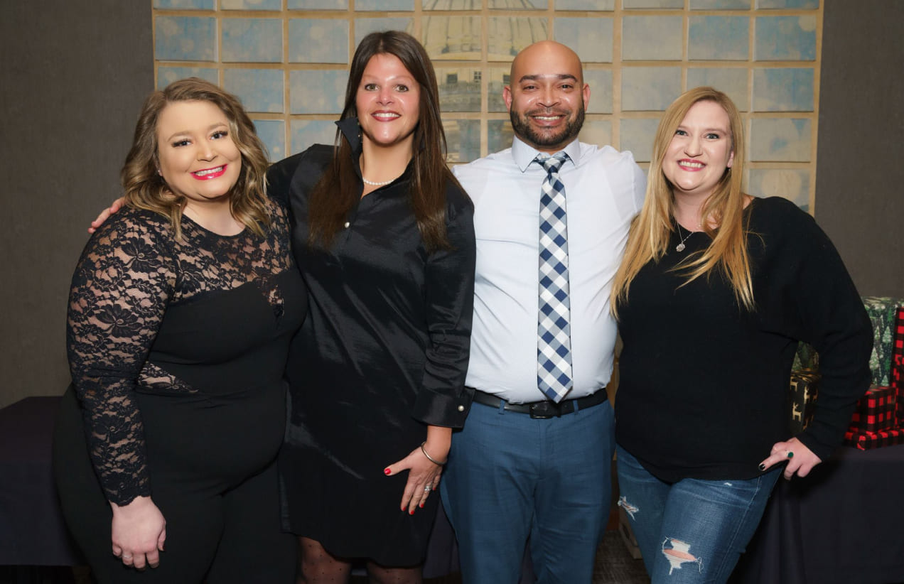 Members of the Investors Associated team pose for a photo at our holiday party.