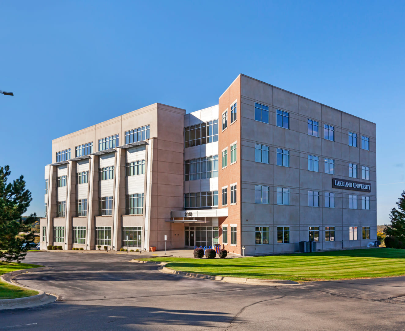 The full front entrance and parking lot of the office building at 2310 Crossroads Drive in Madison, WI.