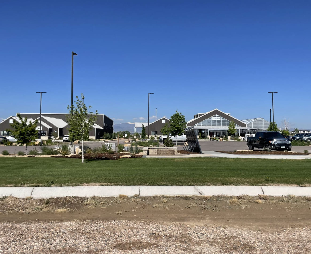 Roadside view of 6166 Weld County Road 74 in Windsor, CO. The property spans two buildings and a parking lot.
