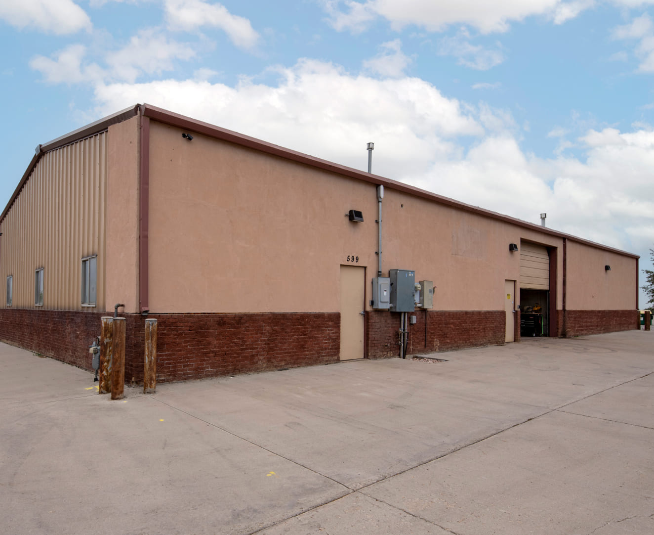 Two doors and a garage door of the industrial property located at 599 71st Street in Loveland, CO.