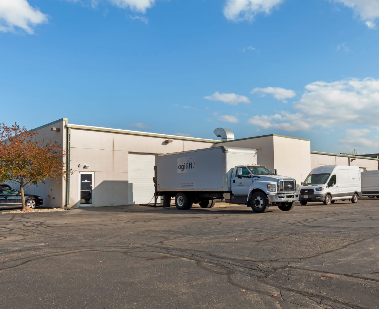The back exterior lot of 5802-5820 Manufacturers Drive in Madison, WI. A truck sits in the lot